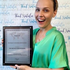 Dr. Natalia Wiechowski holding an award for Marketing 2.0 – outstanding leadership award.