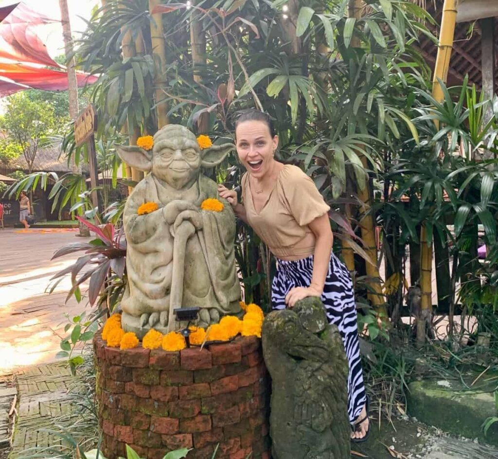 Dr. Natalia Wiechowski standing next to the sculpture of master Yoda.
