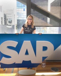 Dr. Natalia Wiechowski standing behind the SAP logo.